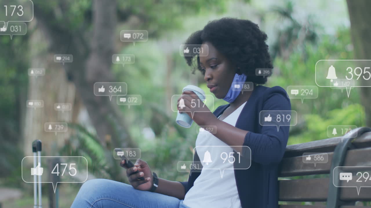 Animation of social media icons over african american woman using smartphone sitting on the bench