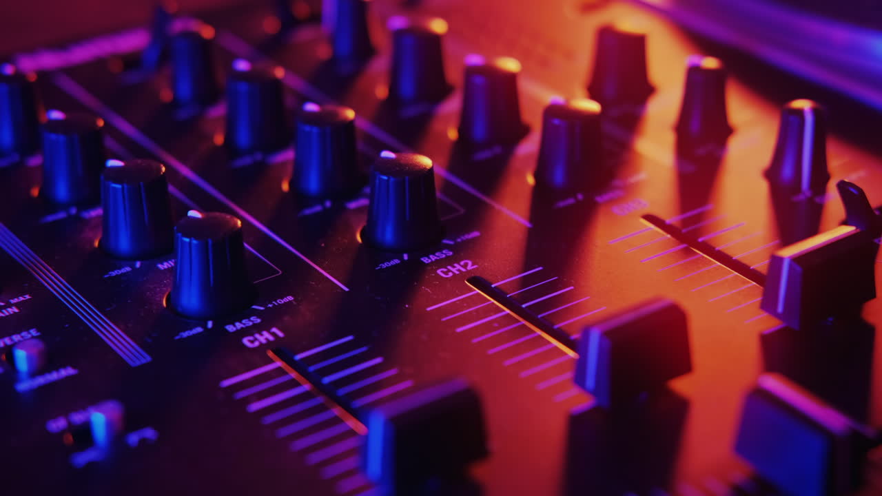 Audio mixing console with neon red and blue illumination around