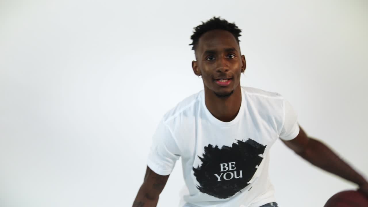 toma en cámara lenta de un afroamericano regateando una pelota de baloncesto-1