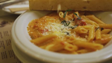 Delicious-Baked-Macaroni-Shredded-With-Cheese-Put-In-The-White-Plate---Close-Up-Shot