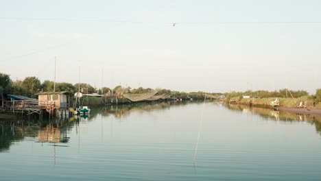 panorama of fishing huts with typical italian fishing machine, called ""trabucco"",lido di dante, fiumi uniti ravenna near comacchio valley