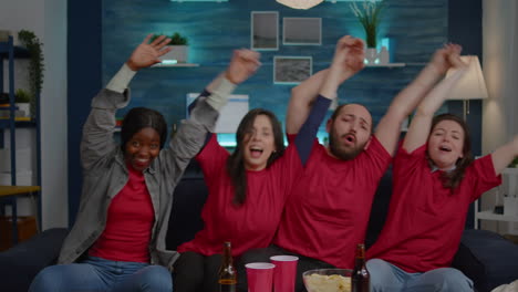 group of multiracial friends enjoying watching sport on television