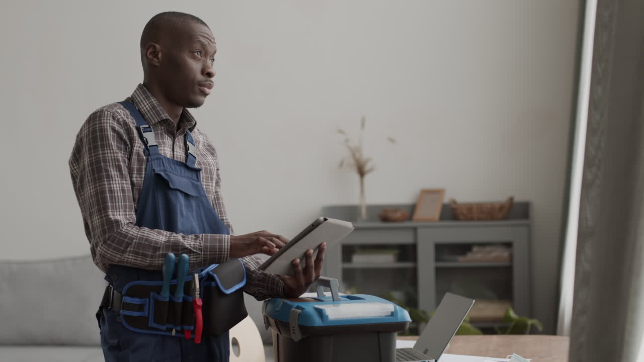 Professional African-American Craftsman Using Digital Tablet