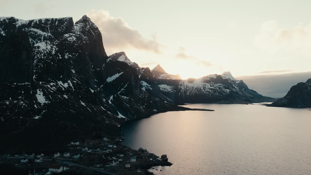 Reine, Lofoten Islands, Nordland, Norway - A Stunning Arctic Coastal Village Nestled Beneath Towering Peaks, Bathed in Golden Light - Aerial Drone Shot