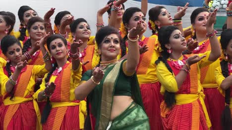 group of bengali girls in traditional saree rehearsing the dance before performance at durga puja procession in kolkata. india.