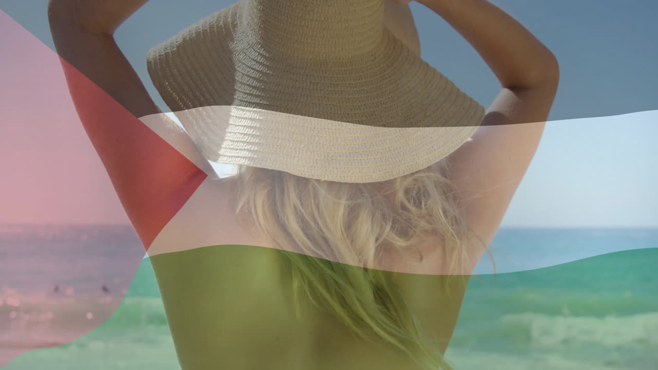 Woman with sun hat on beach, Palestinian flag animation overlay in background