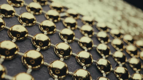 close-up of gold beads on dark background