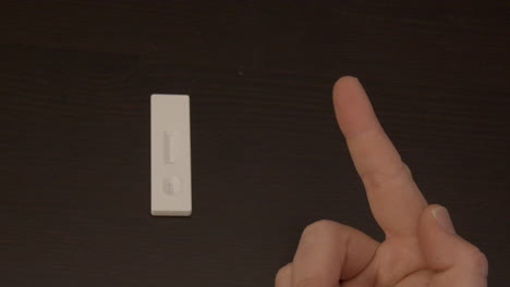 Finger being cleaned with alcohol swab in preparation of Covid-19 self test