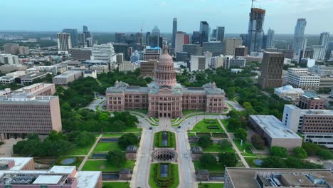 Dramatic-aerial-flight-over-dome-and-statue-reveals-downtown-urban-Austin-Texas-cityscape