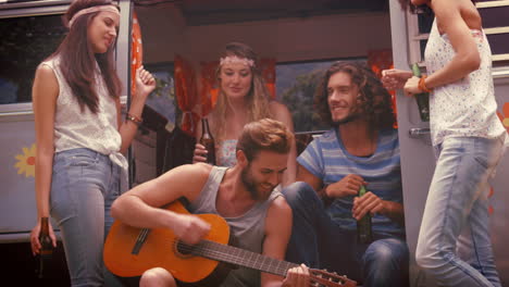 in high quality format hipster friends in camper van at festival