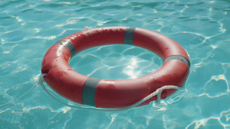 Lifebuoy floating in a sunny and reflective pool