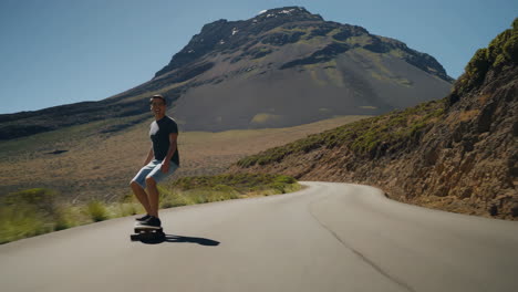 a man skateboarding on a mountain road