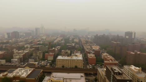 Canadian-wildfire-smoke-covering-buildings-in-Harlem,-New-York-city---Aerial-view