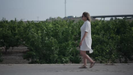 woman walking in an orange grove
