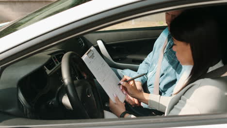 Woman-and-teacher-in-driving-school