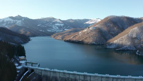 aerial view of a lake surrounded by the snow