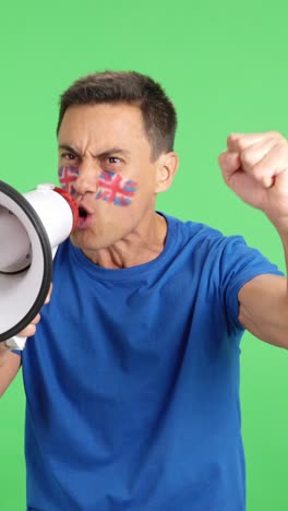 excited man with british flag on face using a megaphone