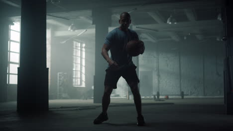 man having basketball training in loft building. player bouncing basketball ball