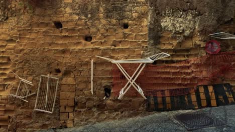 empty alley with clotheslines and stone walls