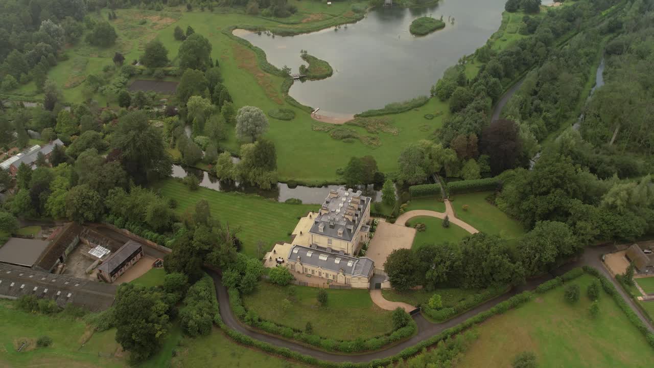 Aerial view flying over Kenwood house majestic estate and gardens in Tufton, Hampshire
