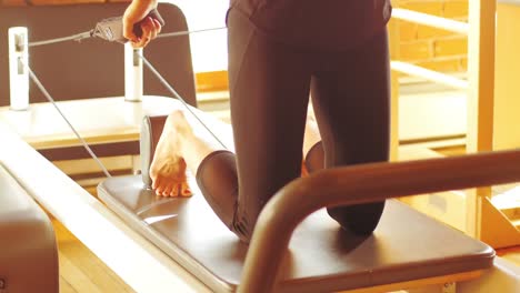 woman exercising on gym equipment