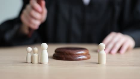 legal judgment and family law decisions represented by gavel and wooden figures