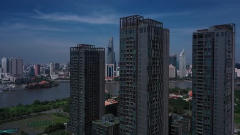 Aerial-Vietnam,-Ho-Chi-Minh-City-iconic-buildings-of-Skyline-on-sunny-clear-day-featuring-architecture,-and-Saigon-River