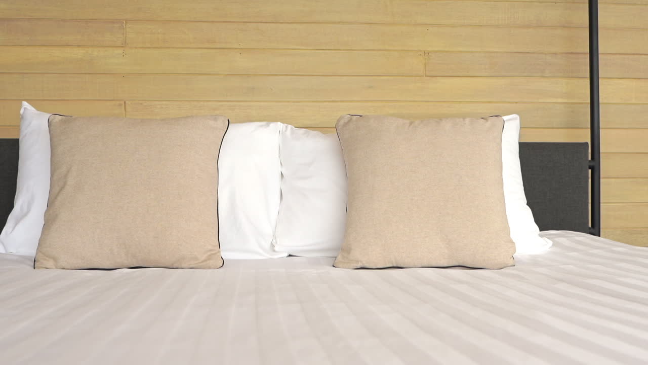 Pan of a comfortable bed with white duvet in a luxury hotel room