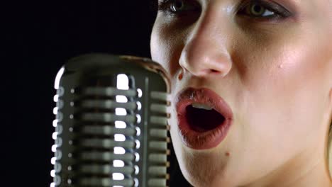 woman singing into a vintage microphone