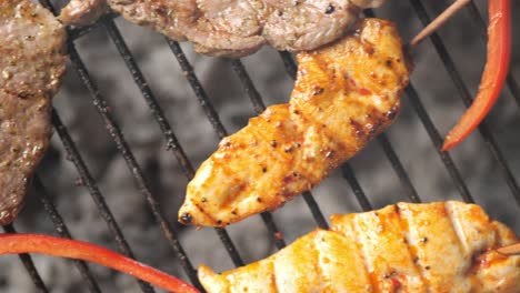 top down panning shot over grill grate with chicken steak and vegetables