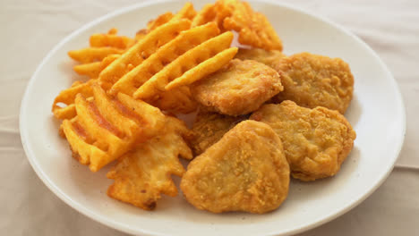 fried chicken nuggets with fried potatoes