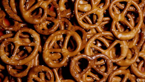 many salted pretzel snacks on a rotating surface