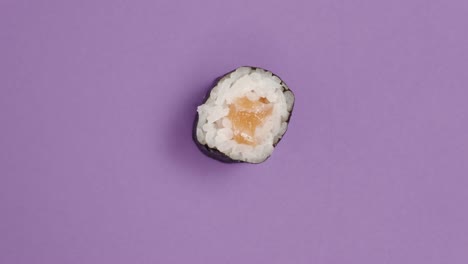 Sushi-roll-rotating-on-violet-background