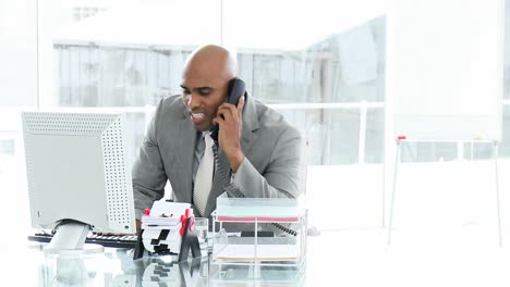 upset businessman looking at a computer