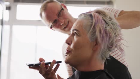 Side-view-woman-talking-at-the-phone-while-hair-styled