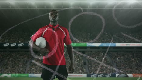 Animation-of-position-plan-over-african-american-man-with-rugby-ball-at-stadium