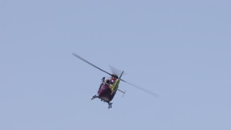 colorful helicopter flying in a clear blue sky