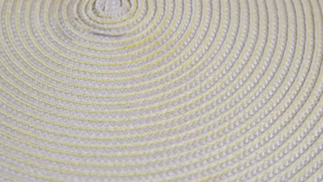 textured light-yellow doily rotating in the scene