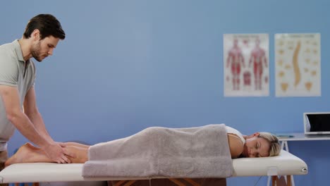 female patient receiving calf massage form physiotherapist