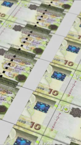 vertical video of 10 libyan dinar banknotes printed by a money press