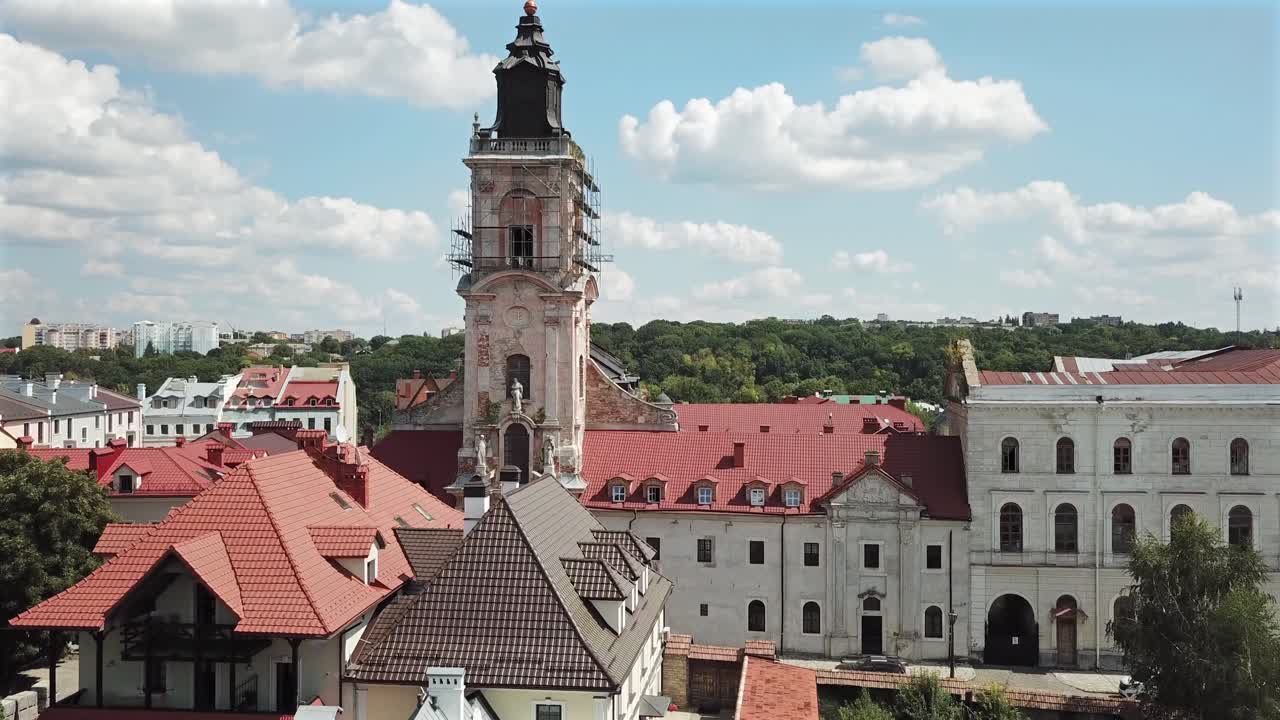 Aerial View of Dominican Monastery's Tower at Kamyanets Podilsky,Ukraine on a sunny day with white clouds.Tilt up and forward.