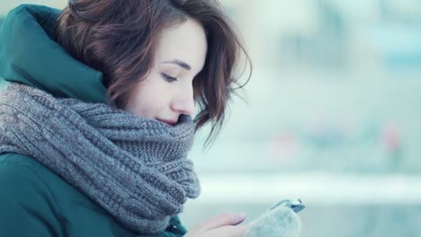 woman using phone in winter