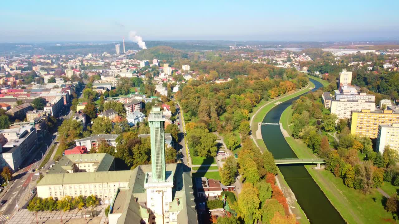 Aerial ascend orbit of Komenskeho Park and Ostrava town hall, Czech Republic in autumn with colorful trees and greenery
