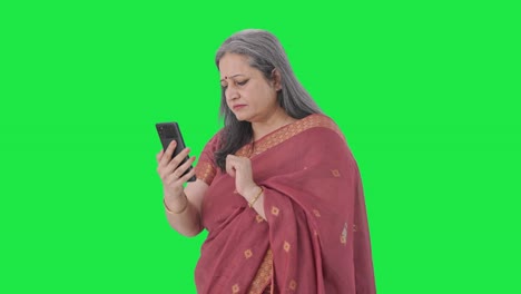 Indian-old-woman-scrolling-through-phone-Green-screen