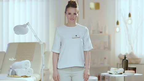 portrait of happy woman worker in modern beauty studio