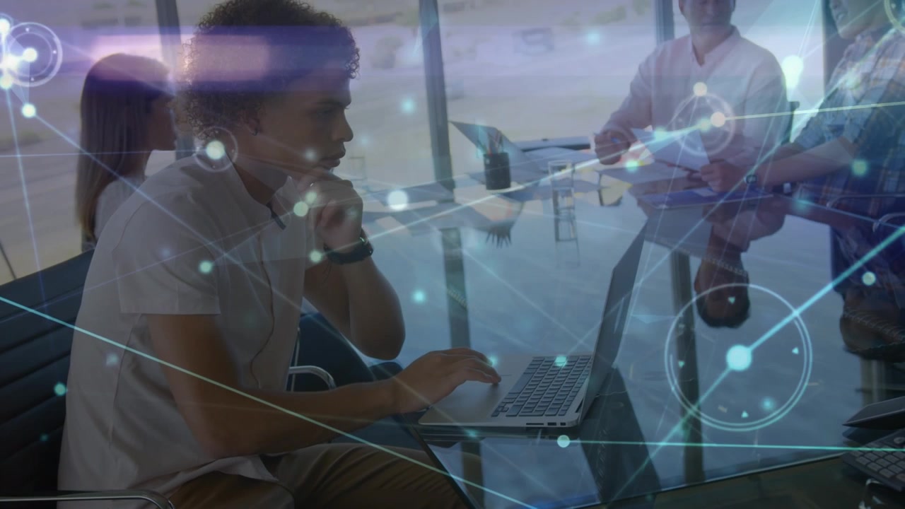 Animation of network of connections over man with laptop and diverse people in office