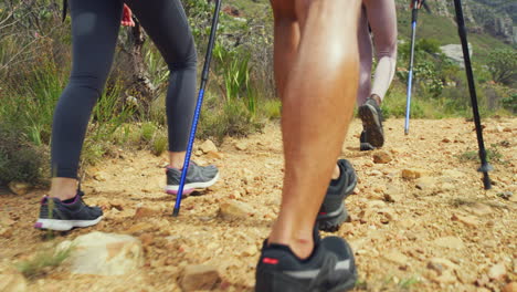 Rearview-of-hikers-walking-on-a-rocky-mountain