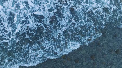 aerial top down drone view of waves and rocks at la bocana el tunco el salvador