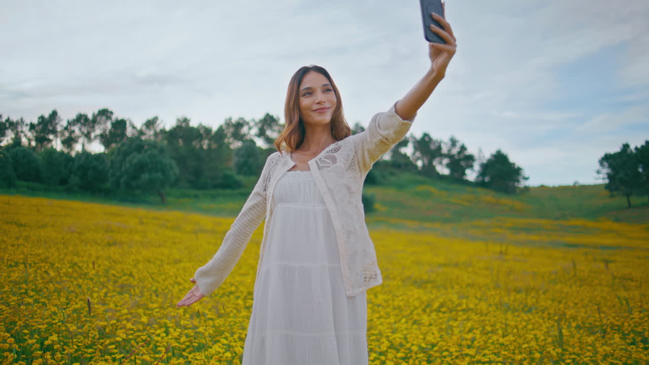 Cheerful girl posing phone camera rural nature closeup. Woman selfie