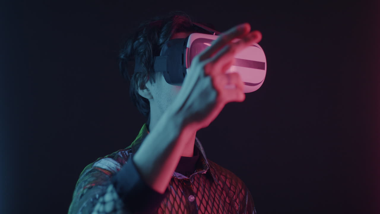 Man Wearing VR Headset in Neon Light
